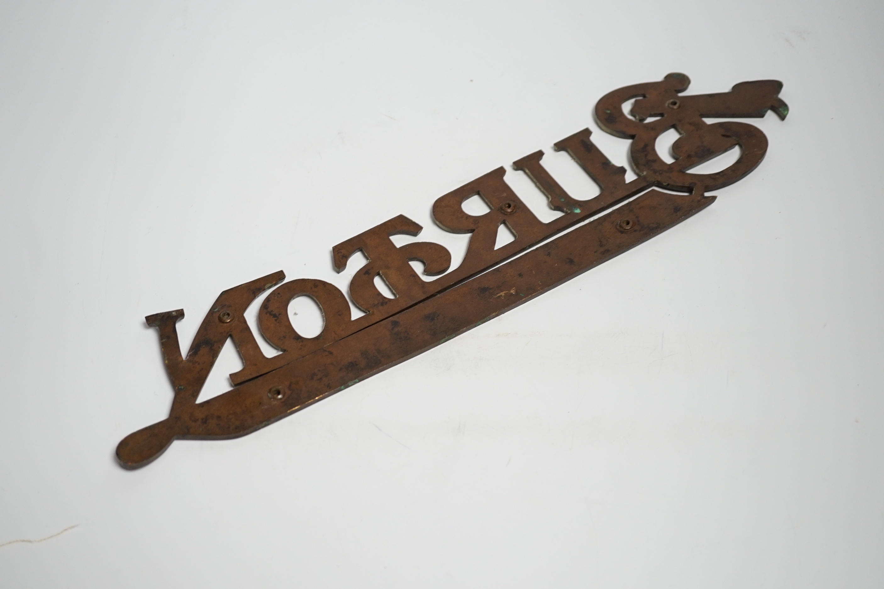 An enamelled bronze 'Montague Burton The Tailor of Taste' shop sign, 41cm wide